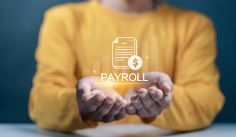 Hands holding a digital payroll icon with financial graph elements, representing comprehensive payroll services in Australia